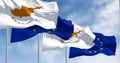 Cyprus national flag waving in the wind with the EU flag on a clear day