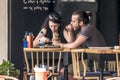 CYPRUS, NICOSIA - JUNE 10, 2019: Young couple eating in street outdoor restaurant. Man and woman enjoying fast food Royalty Free Stock Photo