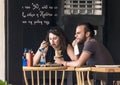 CYPRUS, NICOSIA - JUNE 10, 2019: Young couple eating in street outdoor restaurant. People enjoying fast food in cafe Royalty Free Stock Photo