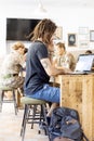 Cyprus, Nicosia - September, 2019: Young man wearing casual clothes using a laptop while sitting at a table in a cafe