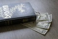 Cyrillic holy bible with money dollars