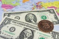 Close up physical bitcoin coin with US dollars and world map. Royalty Free Stock Photo