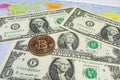 Close up physical bitcoin coin with US dollars and world map. Royalty Free Stock Photo
