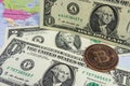 Close up physical bitcoin coin with US dollars and world map. Royalty Free Stock Photo