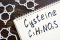 Cysteine with handwritten chemical formula in the notepad. Royalty Free Stock Photo