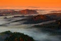 Czech autumn landscape. Hills and villages with foggy morning. Morning fall valley of Bohemian Switzerland park, Ceske Svycarsko,