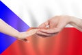 Czech baby and parent hands on the background of flag of Czech Republic Help, aid, support, charity concept