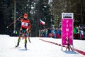 Czech biathlete Michal Slesingr passes the finish sign with winning hand gesture du