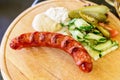 Czech cuisine. Sausage, cucumber, pepper and horseradish in a restaurant. Selective focus