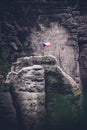 Czech flag at the top of the rock in the powder rocks in the north of Bohemia. a memorable place for climbers. Conquered ground.