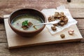 Czech garlic soup with homemade croutons close up in a bowl on the wooden board