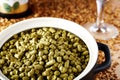 Czech hops granulated in a clay dish.