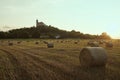 Czech middle age castle Kuneticka Hora with bales of hay and sunset - harvest at the end of summer (Pardubice)