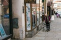 Czech Republic, Blatna, October 05, 2019: An elderly woman walks down the street and looks at a shop window