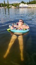 A child with a circle bathes in the lake. A boy in goggles with an inflatable ring swims in the lake Royalty Free Stock Photo