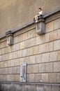 Czech Republic. Klementium. Sculpture of the girl sitting on the wall. 15 June 2016.