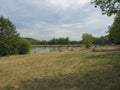 Czech Republic, Marenice, August 3, 2018: People rest on the shore of a pond, bathing and swiming, summer landscape with green lak Royalty Free Stock Photo