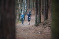 Hannah Pilsen Trail Krkavec. Runners man and woman Running abreast in Forest