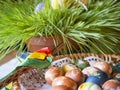 Czech republic, Prague, April 22, 2019: Homemade Colorful Painted easter eggs in wicker basket, easter cookies, Pomlazka