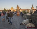 Czech Republic, Prague , September 8, 2018: Begging man with his dog kneeling on Charles Bridge on Mala Strana Bridge