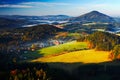 Czech typical autumn landscape. Hills and villages with foggy morning. Morning fall valley of Bohemian Switzerland park. Hills wit