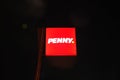 CZECHIA - AUGUST 29, 2023: The illuminated logo of the European retail chain Penny market. Logo of a shop shining into