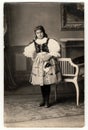 Vintage portrait photo shows girl in folk costum. Photo studio portrait, circa 1930s