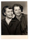 A vintage studio photo portrait shows two women, circa 1960s