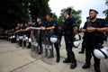 Polish policemen in action, white helmets, plastic covers