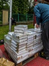 Czestochowa, Poland, May 28, 2023: Dozens of scriptures on a pallet being unloaded by a pallet truck from a truck