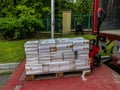 Czestochowa, Poland, May 28, 2023: Dozens of scriptures on a pallet being unloaded by a pallet truck from a truck