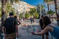 CÃÂ¡diz, Spain - August 7, 2022 - Girl trying to grab a soap bubble next to tourists from behind in street animation Royalty Free Stock Photo