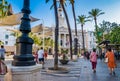 CÃÂ¡diz, Spain - August 7, 2022 - People walking in the famous square of San Juan de Dios with palm tree and city hall building Royalty Free Stock Photo
