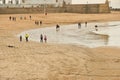 CÃÂ¡diz Spain February 20 2020: Sea winter walks of people on the cold beach of the Atlantic Sea. People chill out in the cold