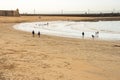 CÃÂ¡diz Spain February 20 2020: Sea winter walks of people on the cold beach of the Atlantic Sea. People chill out in the cold