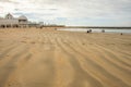 CÃÂ¡diz Spain February 20 2020: Sea winter walks of people on the cold beach of the Atlantic Sea. People chill out in the cold