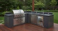 Outdoor kitchen with dark stone countertops set on a wooden deck. Royalty Free Stock Photo