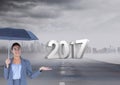 3D 2017 against composite image of woman holding an umbrella on road Royalty Free Stock Photo