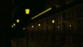 3D animation of night city with lanterns. Design. Deserted alley with yellow lanterns in night city. Train passes over