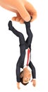 3d big hand catching businessman by foot