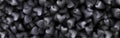 3d black hearts pattern banner background. Scattered hearts like candy