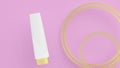 3D rendering illustration. Blank cream tube with golden cap on the pink with golden rings background. Makeup, cosmetic tube for