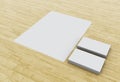 3d Business cards and blank notepads on wooden table. Royalty Free Stock Photo