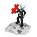 3d businessman in black suite with red puzzle piece in hand Royalty Free Stock Photo