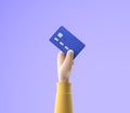 3d cartoon hand holding bank credit card isolated over blue background