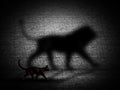 3D cat walking with lion shaped shadow against a brick wall Royalty Free Stock Photo