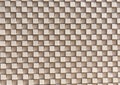 A 3D checkerboard pattern of beige bricks