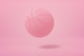3d close-up rendering of light pink basketball bouncing on light pink background.
