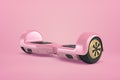 3d close-up rendering of metallic pink gyroscooter standing on pink background.