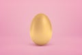 3d close-up rendering of shiny golden egg standing on yogurt pink background.